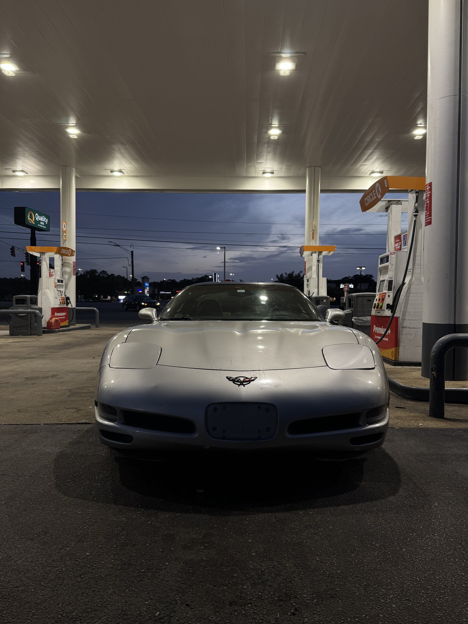 Silver C5 Corvette — head-on at a Circle K at dusk