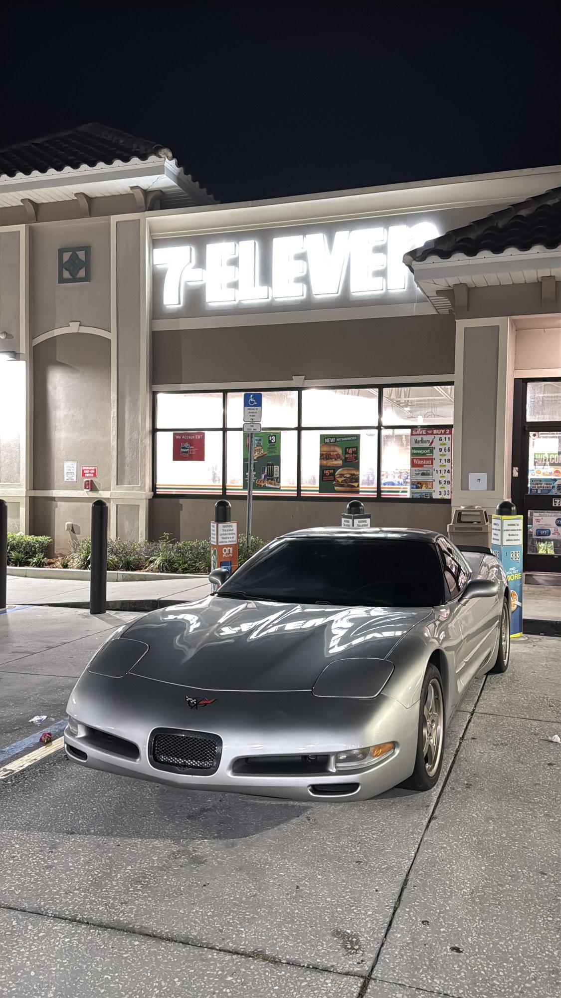 Silver C5 Corvette — front three-quarter at night